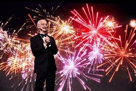 Dr. Woodie Flowers with fireworks in background.